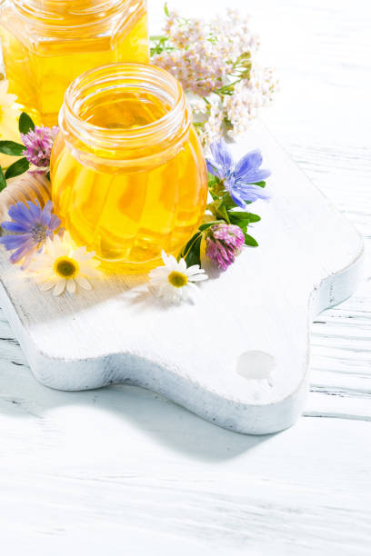 istock jars with fresh flower honey on white wooden board 656318778