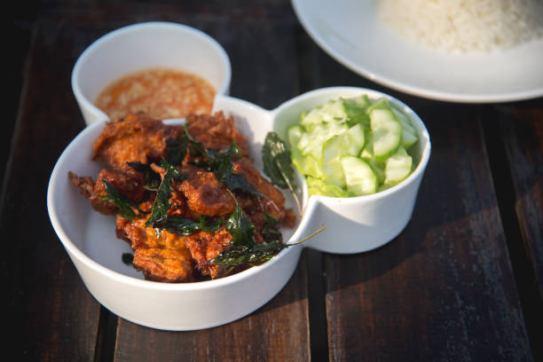 istock fried fish and cucumber with sauce and rice 656319360