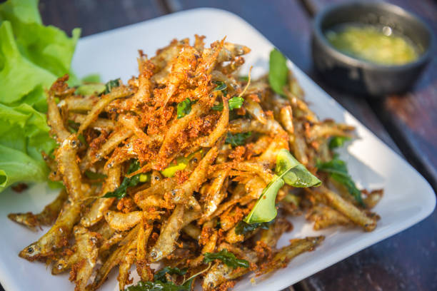 istock fried fish and cucumber with sauce on wood table. 656319362