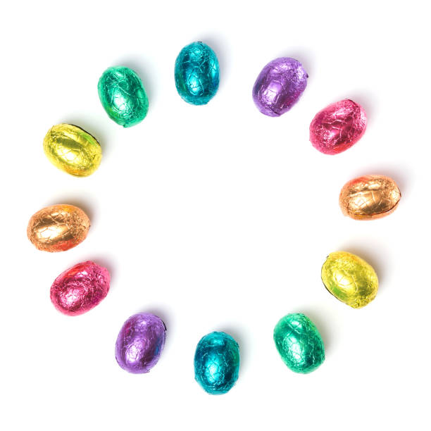 istock Circle made of chocolate easter eggs wrapped in multi colored foil isolated on white background 656325034
