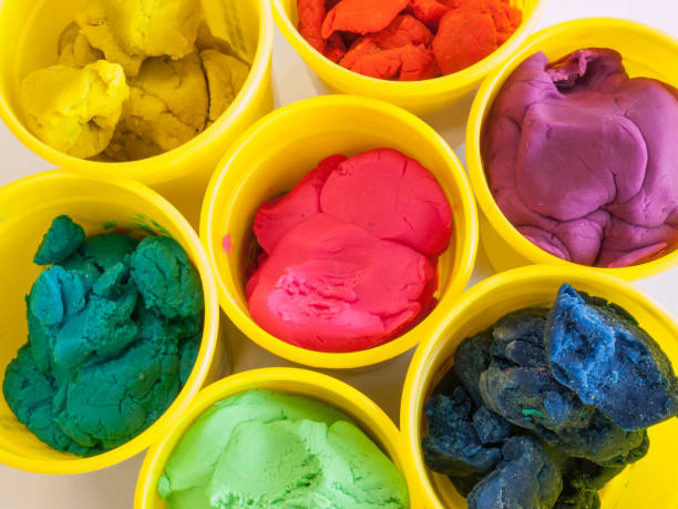 colorful play dough in yellow can Colorful play dough in yellow cans in white background. clay sculpture stock pictures, royalty-free photos & images