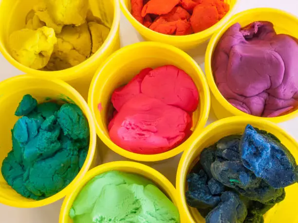 Photo of colorful play dough in yellow can