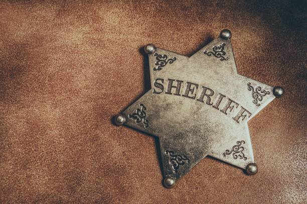 sheriff badge on brown leather texture background. - sheriff imagens e fotografias de stock