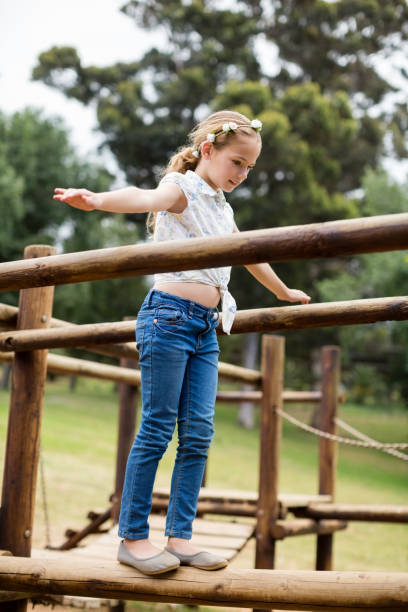 istock Girl playing on a playground ride in park 656328308