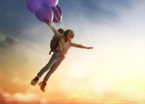 Photo of Child flying on balloons