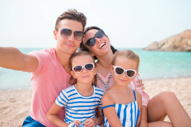 istock Young beautiful family taking selfie on the beach 656332582