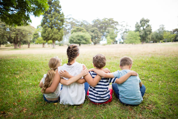 istock Kids sitting together in park 656335878