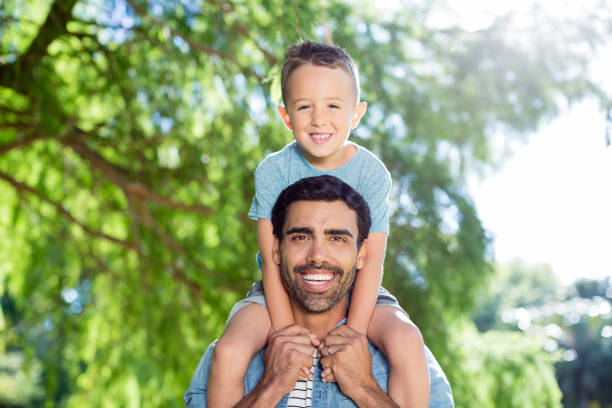 istock Father carrying son on his shoulders 656336104