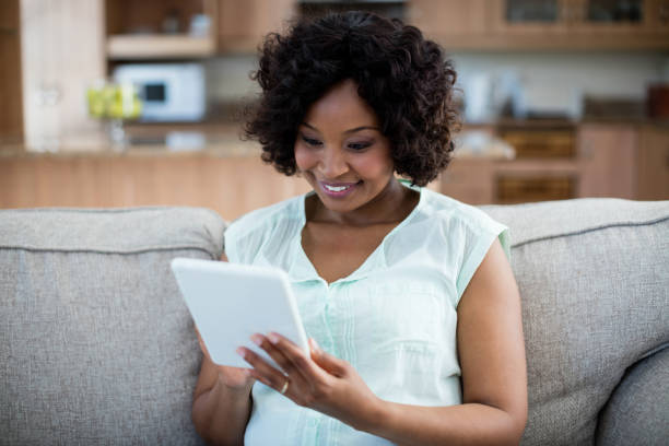 istock Woman using digital tablet in living room 656346098