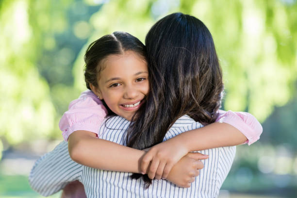 istock Girl embracing her mother in park 656349970