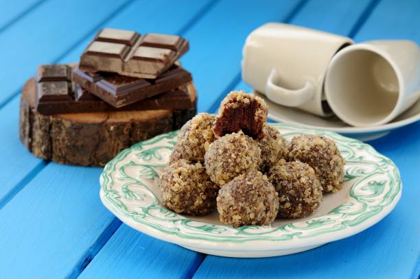 istock Homemade chocolate truffles, chocolate and coffee cups on bright blue 656350884