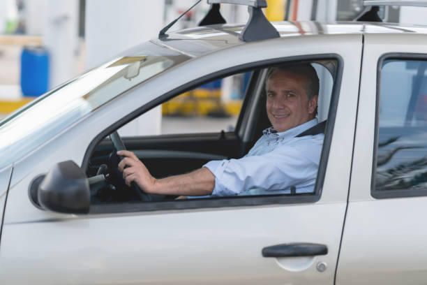 istock Man driving in at a gas station 656353196