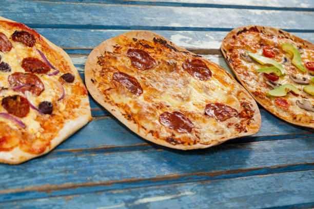 istock Various delicious italian pizza served on wooden plank 656363308