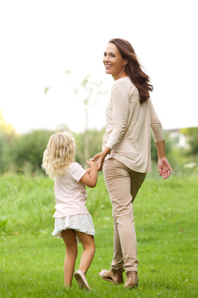 istock Young woman with her daughter walking in park 656363928