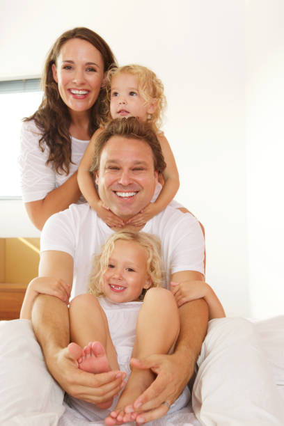 istock Cheerful young family in bed at home 656364058