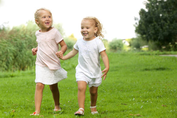 istock Two little girls walking in the park 656364200