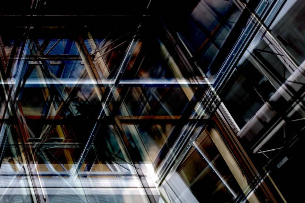 istock Modern architecture with reflections. Steel and glass. Structural glazing. Grunge multiple exposure photo of industrial / office building fragment in metallic colors. 656366918