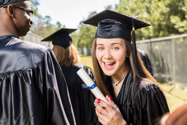 istock Latin descent college, high school student waits at graduation. 656378196