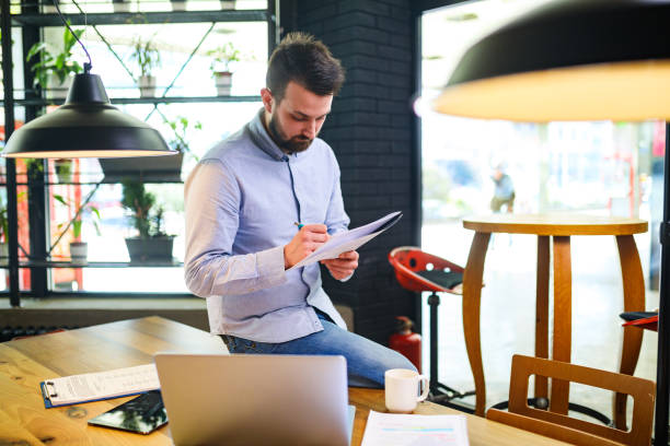 istock Pensive businessman reviewing paperwork in office 656382864