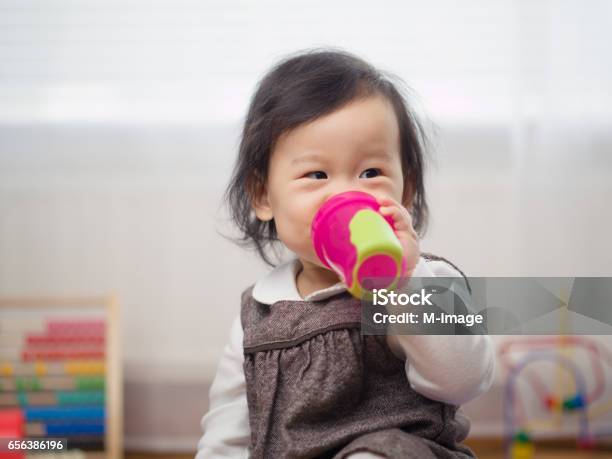Baby Girl Drinking Water Stock Photo - Download Image Now - Baby Cup, Child, Drinking