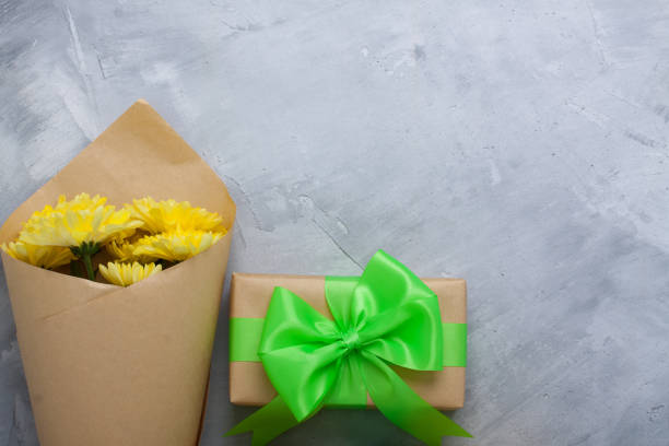 istock Gift box bouquet yellow chrysanthemums on grey concrete background 656386854