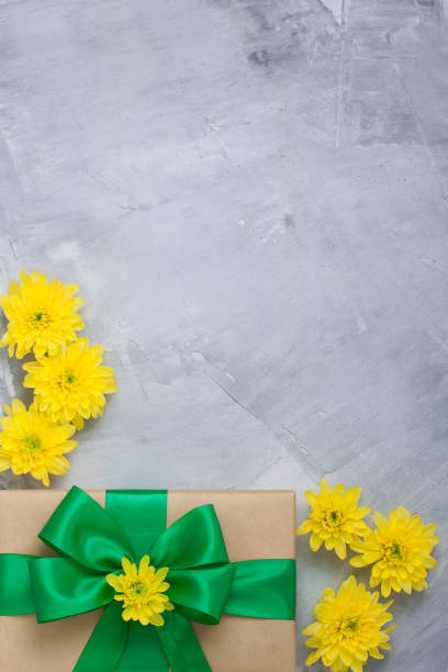 istock Gift box bouquet yellow chrysanthemums on grey concrete background 656386918