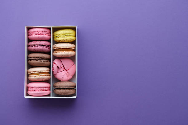 istock Box of colorful macarons on purple background 656394786
