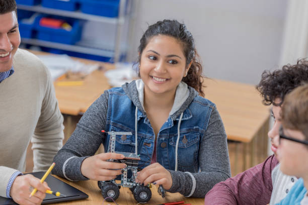 istock Confident female STEM school student builds robot 656396204