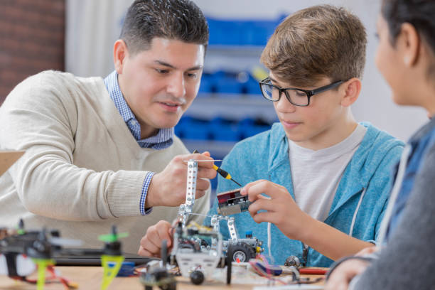 istock STEM high school teacher works with student 656396212
