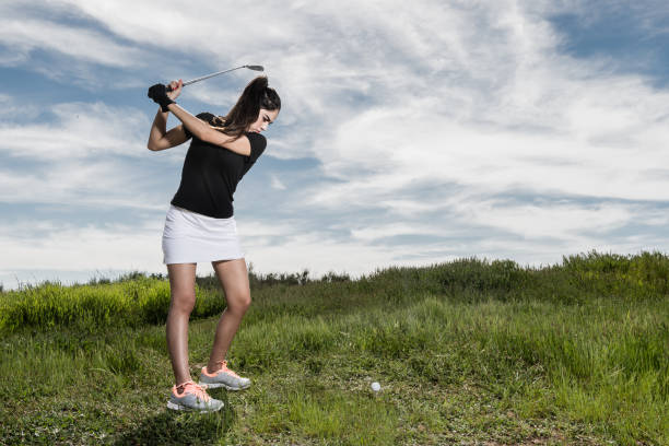 istock Young Hispanic Women Hitting A Golf Ball 656399232