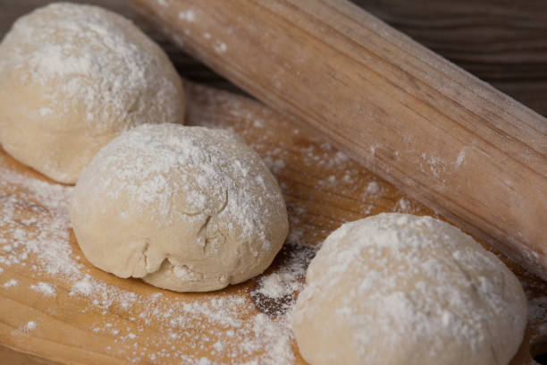 istock Rolling pin with pizza dough and flour on chopping board 656399682