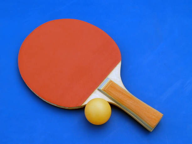 istock red table tennis (ping-pong) racket with orange ball on blue table 656402908