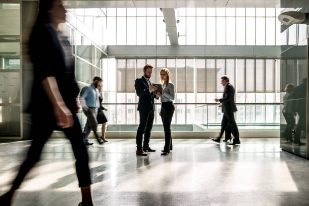 istock Business people walking through the lobby. 656410534