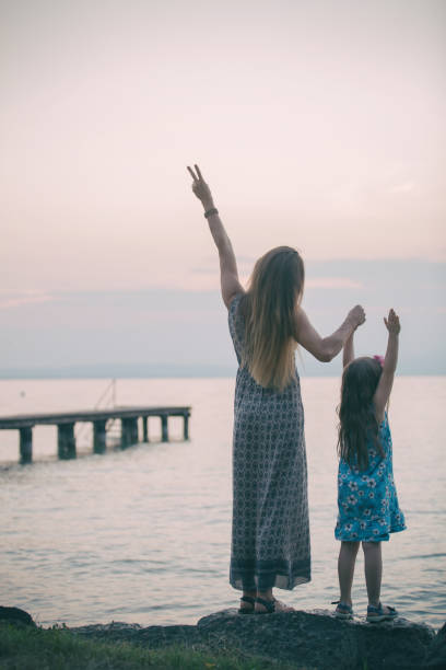 istock Mother and daughter on the sea 656413396