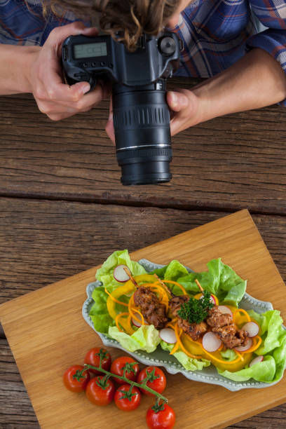 istock Photographer clicking a picture of food using digital camera 656414974