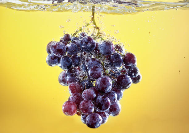 istock grapes drop in tank filled with water 656417390