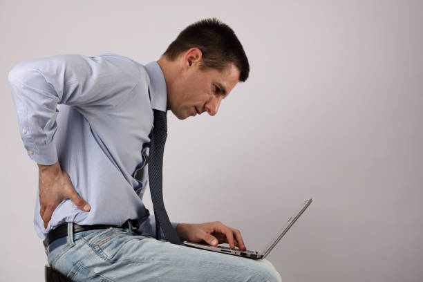 business man with back pain. pain relief concept - low back imagens e fotografias de stock
