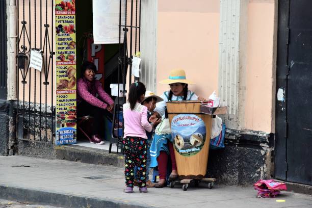 Arequipa,Peru. January 28, 2017. Local Women dressed in traditional clothing selling local Ice Cream in the main square of the city.