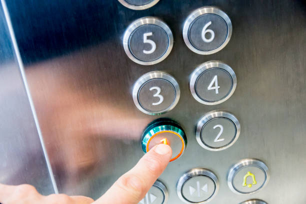 istock Man's hand causes first floor in metal elevator 656424060
