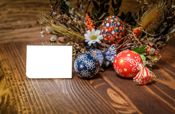 Easter wreath with Easter eggs on the wooden background. Easter themed. Easter symbol.