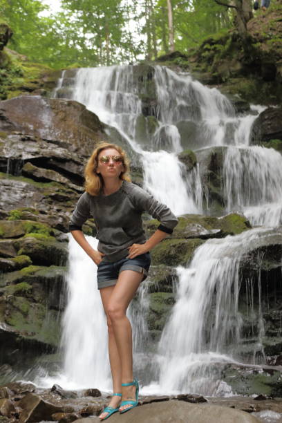 istock Woman on front of waterfall. 656425340