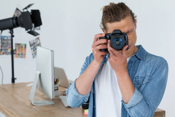 istock Photographer clicking picture using digital camera 656431078