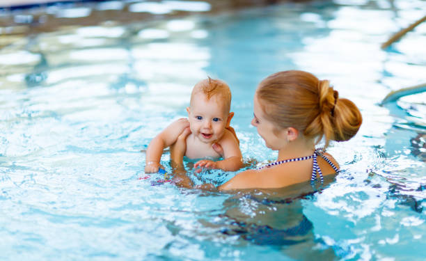 istock Mother and baby swim  in pool 656431310