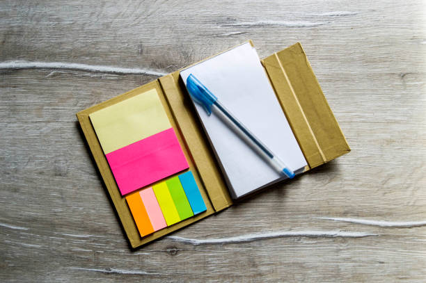 istock Pencil and note pad for note taking, sticky colored papers, colored sticky paper for taking notes, business man and notepad, business man and organizer, 656434434