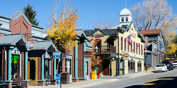Breckenridge, Colorado, USA - October 12, 2015: Main Street runs through the town of Breckenridge, Colorado which was founded in November 1859 by General George E. Spencer. The town is now a famous ski resort and attracts visitors and tourists all year long. Breckenridge has many upscale shops, stores and restaurants many of which are located in the historic, Victorian-era buildings. Winter brings skiing and snowboarding and in Spring, Summer and Fall outdoor sports such as hiking and mountain biking are available for outdoor enthusiasts.