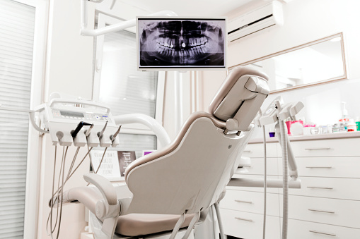Modern dentist office. Place for beautiful smile. Modern dental practice. Dental chair and other accessories used by dentists