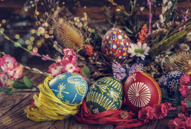 istock colored Easter eggs with wheat ears on the wooden background. Easter themed. Easter symbol. 656435606