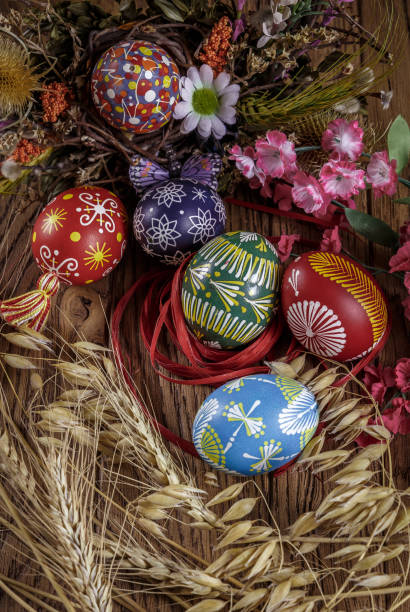 istock colored Easter eggs with wheat ears on the wooden background. Easter themed. Easter symbol. 656438068