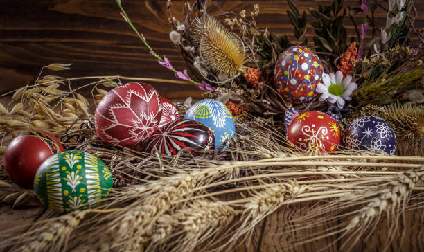 istock colored Easter eggs with wheat ears on the wooden background. Easter themed. Easter symbol. 656438340
