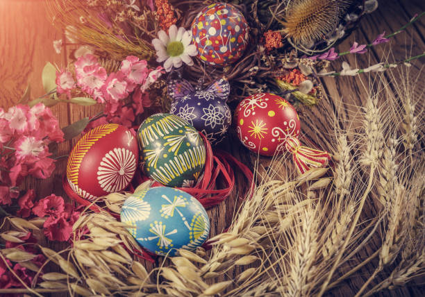 istock colored Easter eggs with wheat ears on the wooden background. Easter themed. Easter symbol. 656438528